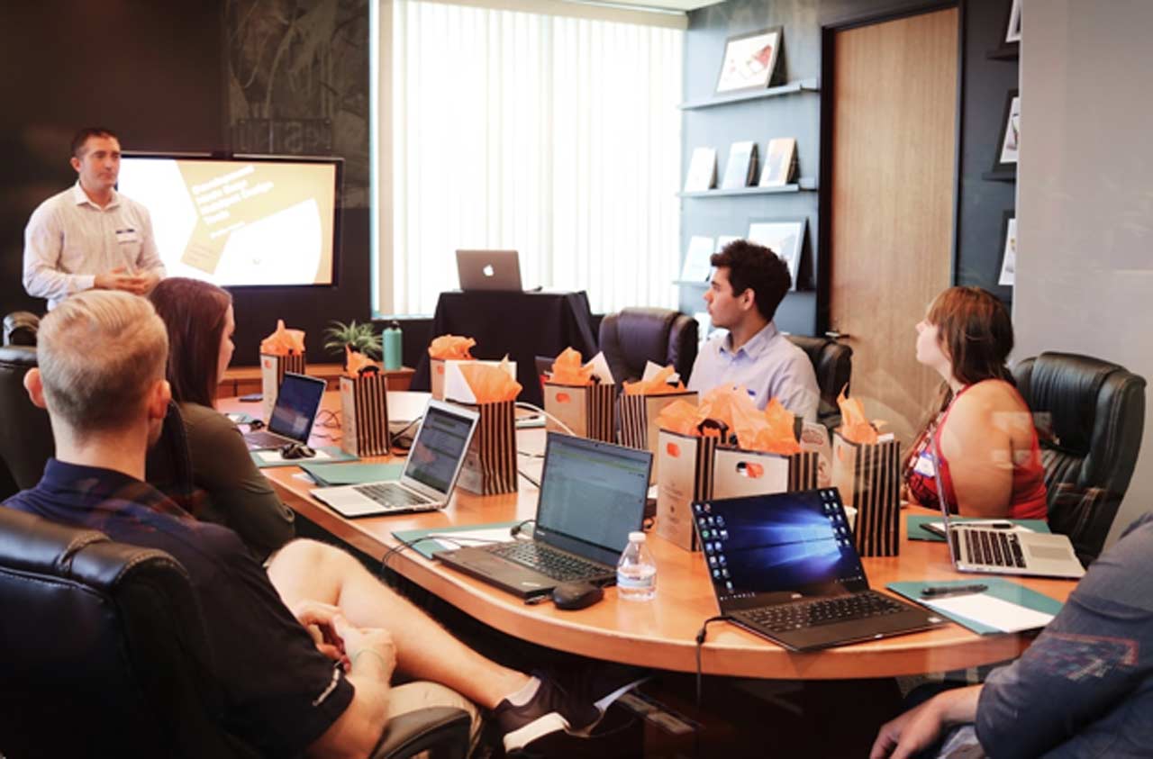 A team in an office discussing PSA software during a meeting