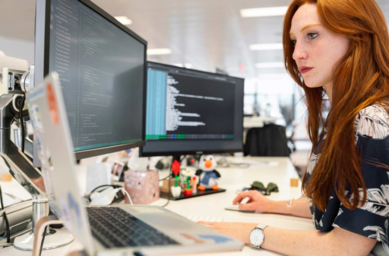 A woman in an office researching PSA software on her computer