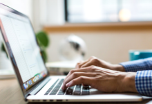 A man using a laptop to research and select the ideal texting software for his nonprofit organization.