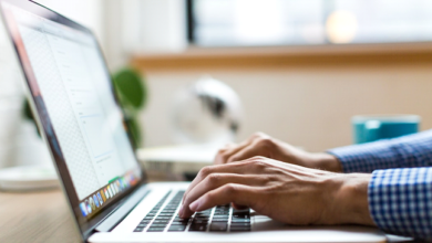 A man using a laptop to research and select the ideal texting software for his nonprofit organization.